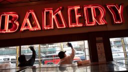 Employees of Junior's Restaurant sanitize a window, Thursday, March 19, 2020 in the Brooklyn borough of New York. The restaurant is closed temporarily due to the coronavirus. (AP Photo/Mark Lennihan)
