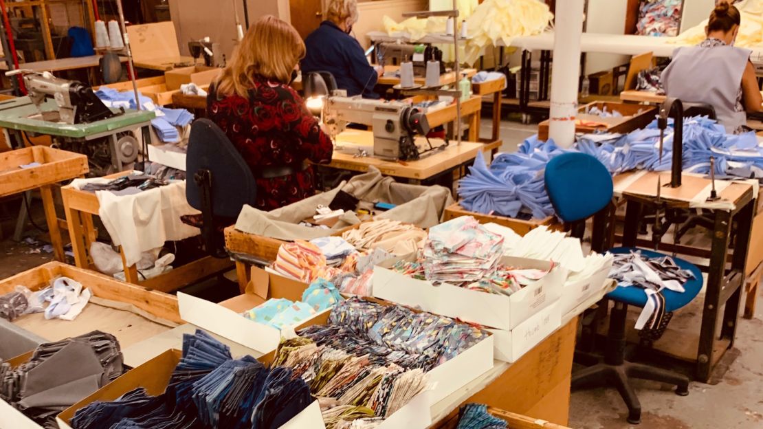 Workers hand-sewing Blade + Blue face masks. 